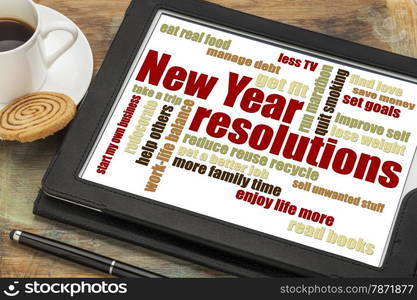 New Year goals or resolutions - a word cloud on a digital tablet with cup of coffee