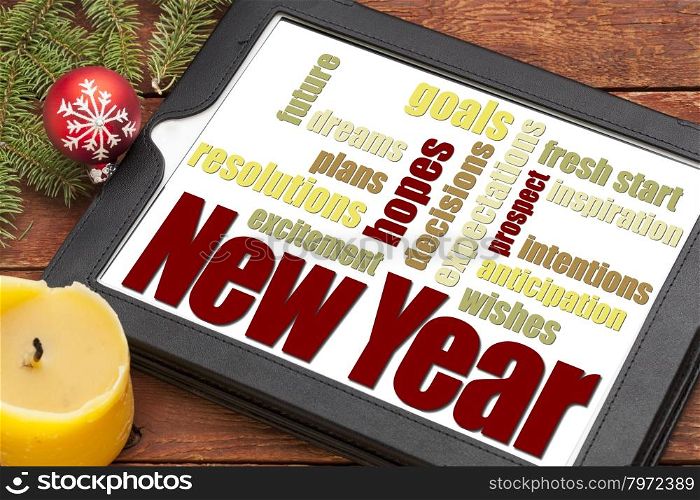 New Year goals. plans and expectations - a word cloud on a digital tablet with holiday decoration