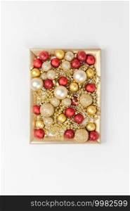 New Year or Christmas pattern flat lay top view Xmas holiday celebration decorative toy balls sparkles isolated white paper background copy space Template frame for greeting card your text design