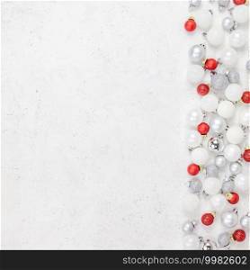 New Year or Christmas pattern flat lay top view Xmas holiday celebration decorative toy balls sparkles white concrete background copy space Template frame for greeting card your text design