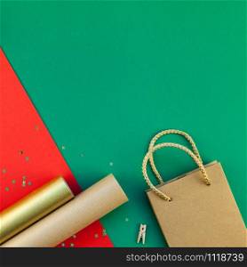 New Year or Christmas presents preparation DIY flat lay top view Xmas holiday celebration handmade gift boxes on red green paper background. Template mockup for greeting card or your text design 2019