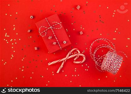 New Year or Christmas presents wrapped ribbon flat lay top view 2019 Xmas holiday celebration handmade gift boxes red paper golden sparkles background. Template mockup greeting card your text design