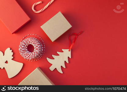 New Year or Christmas presents wrapped with ribbon flat lay top view Xmas holiday 2019 celebration handmade gift boxes on red paper background copyspace. Template mockup greeting card your text design