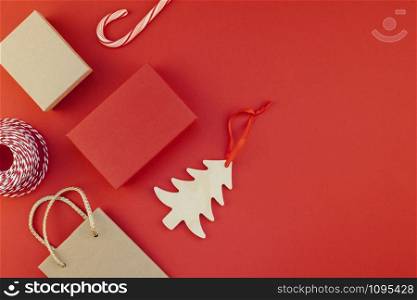 New Year or Christmas presents wrapped with ribbon flat lay top view Xmas holiday 2019 celebration handmade gift boxes on red paper background copyspace. Template mockup greeting card your text design