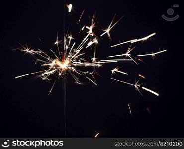 New year party sparkler on black background. Bengal fire. High quality photo. New year party sparkler on black background. Bengal fire