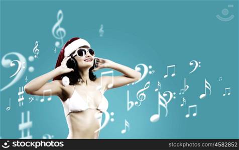 New Year Party. Young Santa girl in white bikini and headphones