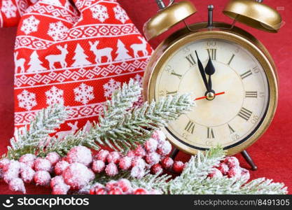 New year red background with snow fir christmas tree, alarm clock and gift bag. the red clock counts down to twelve.. Christmas snow fir tree, alarm clock and gift bag on red background.