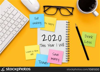 New Year Resolution Goal List 2020 - Business office desk with notebook written in handwriting about plan listing of new year goals and resolutions setting. Change and determination concept.