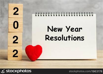 New Year Resolution words and 2022 cubes with red heart shape decoration on table. Goal, plan, health, Love and Happy Valentine day concept