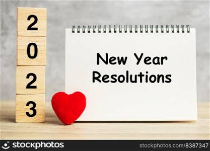 New Year Resolution words and 2023 cubes with red heart shape decoration on table. Goal, plan, health, Love and Happy Valentine day concept