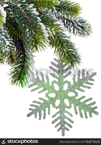 New Year&rsquo;s snow-covered branch of a Christmas tree and decorative snowflake
