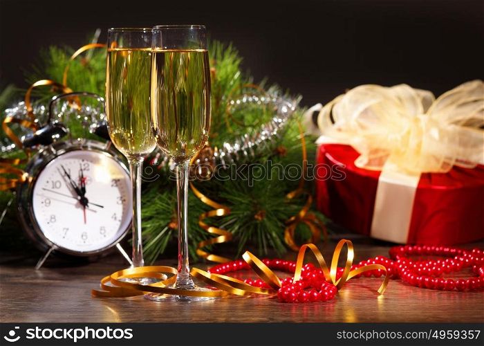 New Year&rsquo;s still life with glasses. New Year&rsquo;s still life with glasses of champagne. Decorations and ribbons on a bright color background