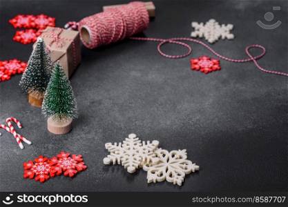 New Year&rsquo;s toys and decorations on a dark concrete background. Getting home ready for Christmas celebrations. Christmas toys and decorations on a dark concrete background
