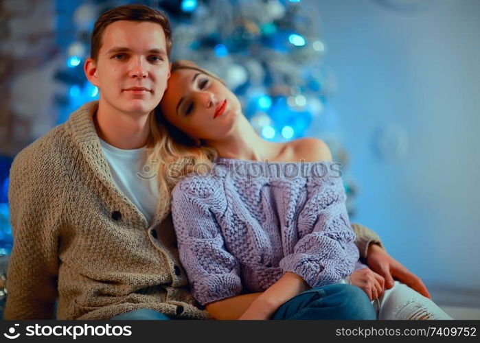 New Year’s photo people / young man and girl in the Christmas interior, cozy decorated house