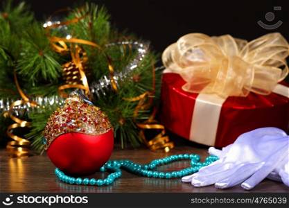 New Year's still life. Decorations and ribbons on a bright color background