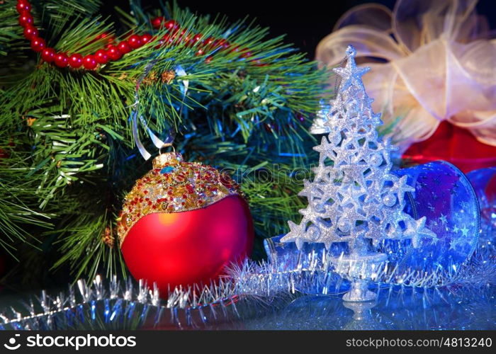 New Year's still life. Decorations and ribbons on a bright color background