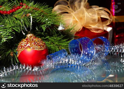 New Year's still life. Decorations and ribbons on a bright color background