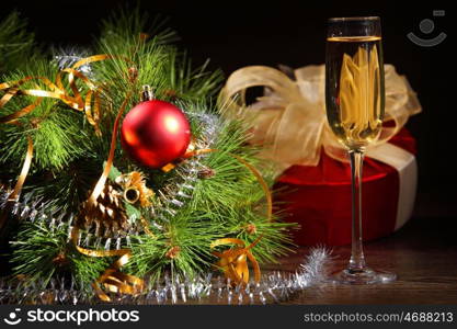 New Year's still life with glasses of champagne. Decorations and ribbons on a bright color background
