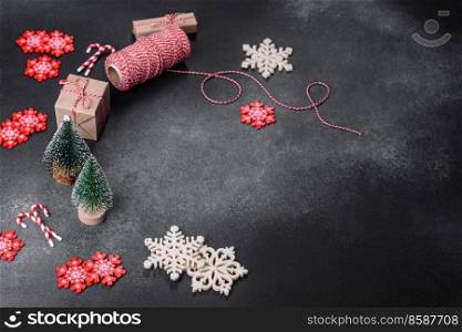 New Year’s toys and decorations on a dark concrete background. Getting home ready for Christmas celebrations. Christmas toys and decorations on a dark concrete background
