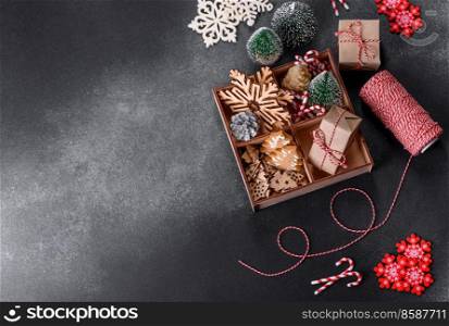 New Year’s toys and decorations on a dark concrete background. Getting home ready for Christmas celebrations. Christmas toys and decorations on a dark concrete background
