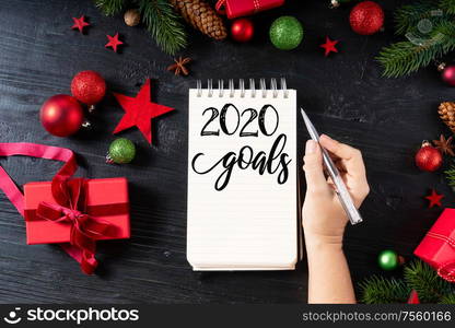 New Years 2020 golas with red git boxes, Christmas celebration and gift giving concept, copy space on wooden background. Christmas flat lay scene with golden decorations