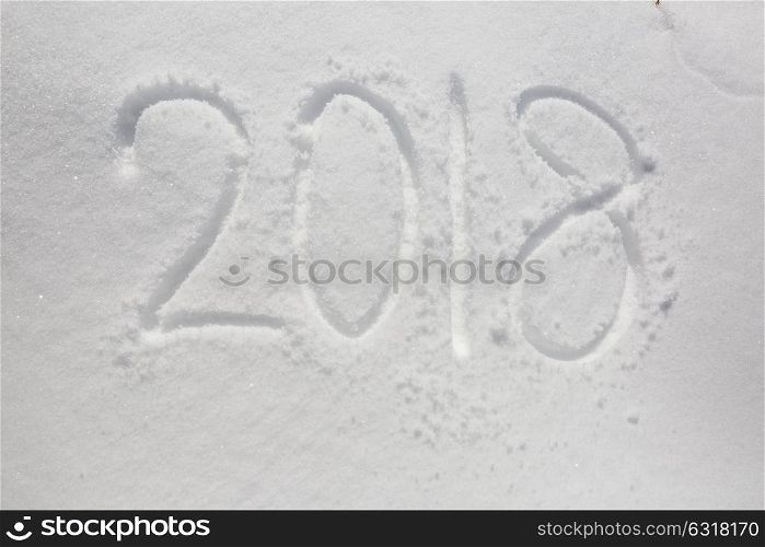 new years date 2018 written in snow background