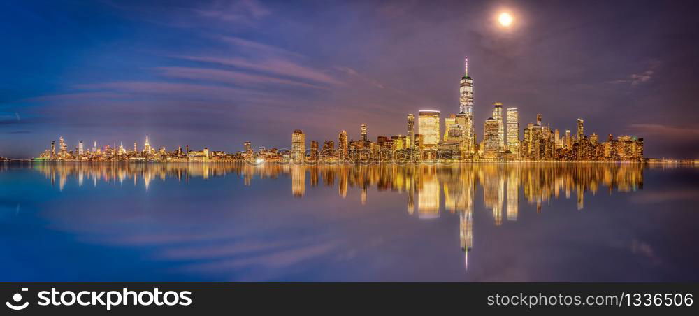New York and New Jersey skyline from new jersey deck at sunset blue hour with reflection on hudson river