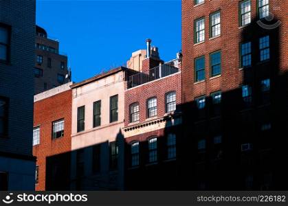 New York apartment buildings with old brick wall.