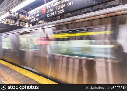 NEW YORK CITY - DECEMBER 1, 2018: Subway train moves fast in the station. Opened in 1904, the New York City Subway is one of the world&rsquo;s oldest public transit systems.