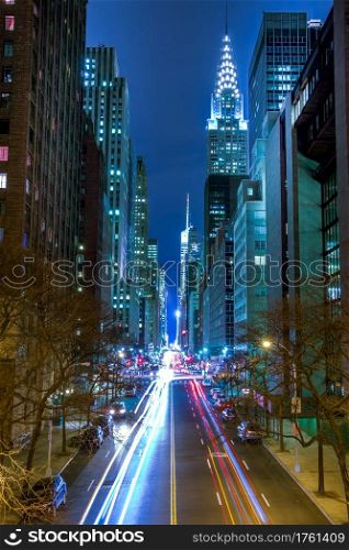 New York City. Night Traffic on 42nd Manhattan Street. Car headlights, traffic lights and street lamps