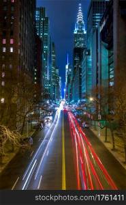 New York City. Night Traffic on 42nd Manhattan Street. Car headlights, traffic lights and street lamps