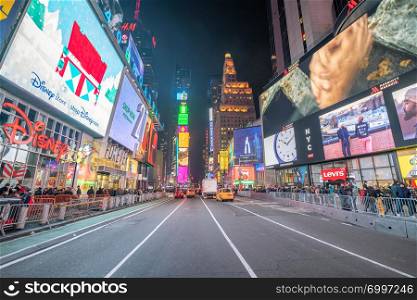 NEW YORK CITY - NOVEMBER 30, 2018: Times Square ads on a winter night. Times Square is a major tourist attraction in Manhattan.