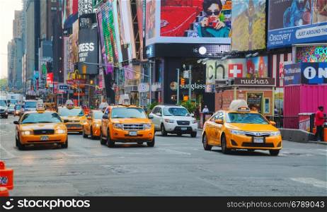 NEW YORK CITY - SEPTEMBER 04: Yellow cabs at Times square on October 4, 2015 in New York City. It's major commercial intersection and neighborhood in Midtown Manhattan at the junction of Broadway and 7th Avenue.