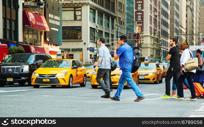 NEW YORK CITY - SEPTEMBER 04: Yellow cabs with people in the morning on September 4, 2015 in New York City.