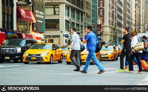 NEW YORK CITY - SEPTEMBER 04: Yellow cabs with people in the morning on September 4, 2015 in New York City.