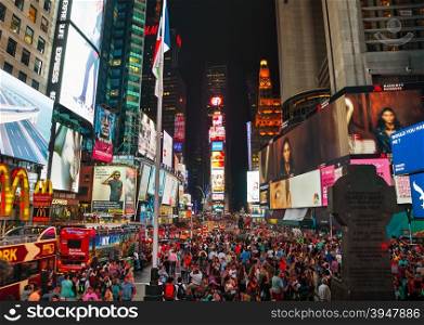 NEW YORK CITY - SEPTEMBER 05: Times square with people in the night on September 5, 2015 in New York City. It&rsquo;s major commercial intersection and neighborhood in Midtown Manhattan at the junction of Broadway and 7th Avenue.