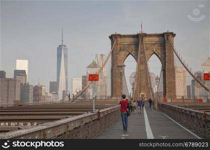 NEW YORK CITY - SEPTEMBER 3: Brooklyn bridge with people on September 3, 2015 in New York City. It's a bridge in New York City and is one of the oldest suspension bridges in the US.