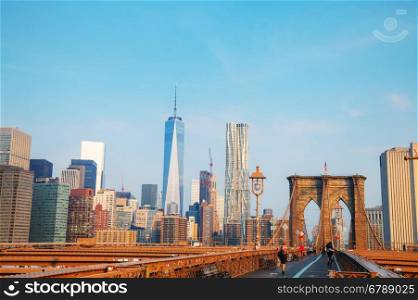 NEW YORK CITY - SEPTEMBER 3: Brooklyn bridge with people on September 3, 2015 in New York City. It's a bridge in New York City and is one of the oldest suspension bridges in the US.