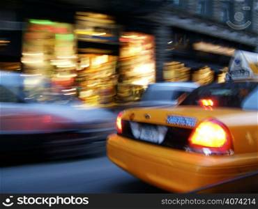 New York City street in motion with yellow cab
