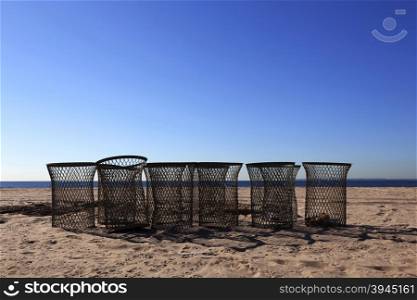 new york city, usa, 15 september 2015: empty trash baskets on sunny morning beach of coney island