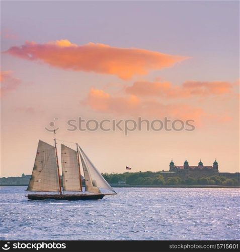 New York sailboat sunset and Ellis Island from Manhattan US