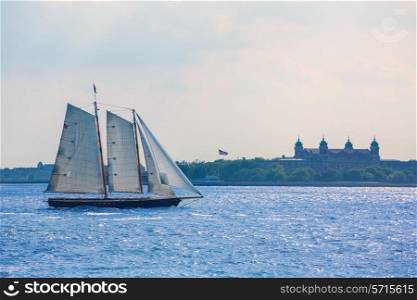 New York sailboat sunset and Ellis Island from Manhattan US