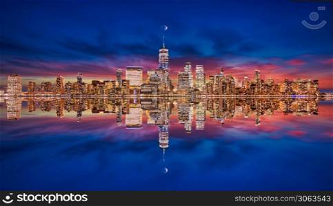 New York skyline from New Jersey on the blue hour with moon and reflection of skyscrapers on the Hudson river with lights on