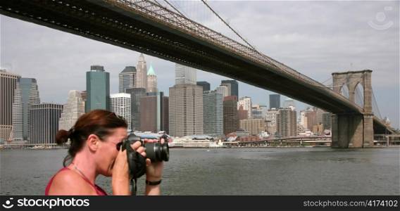 New York skyline with a woman taking a photo