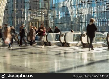 NEW YORK, USA - APR 2019 : Unrecognizable passenger and tourist walking up to the escalator to office in rush hour on April 3, 2019, lower Manhattan,New York, United state