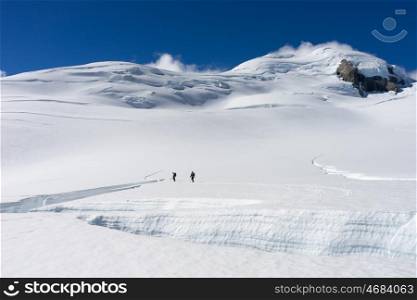 New Zealand. Group of people walking among snows of New Zealand Alps