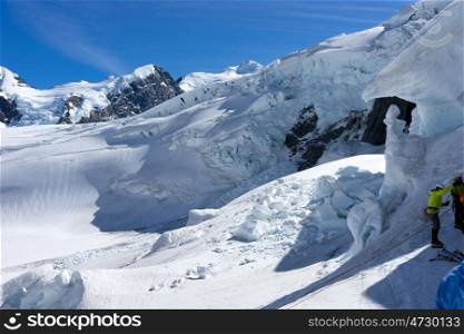 New Zealand. Group of people walking among snows of New Zealand mountains