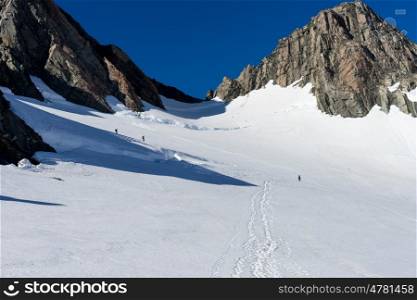 New Zealand. Group of people walking among snows of New Zealand mountains