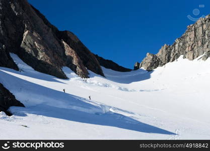 New Zealand. Group of people walking among snows of New Zealand mountains