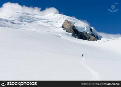 New Zealand. Man walking among snows of New Zealand mountains